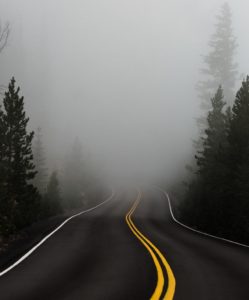 road heading into heavy fog